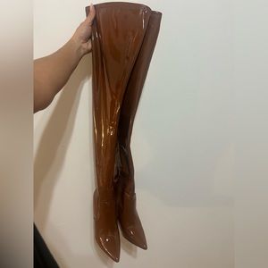 These thigh high heel boots are a size 7M.